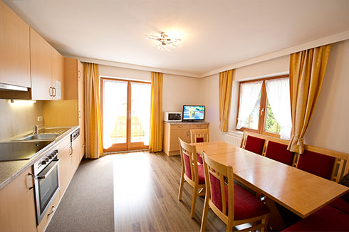 Kitchen with a sitting area in apartment 2 of Tiroler Bua